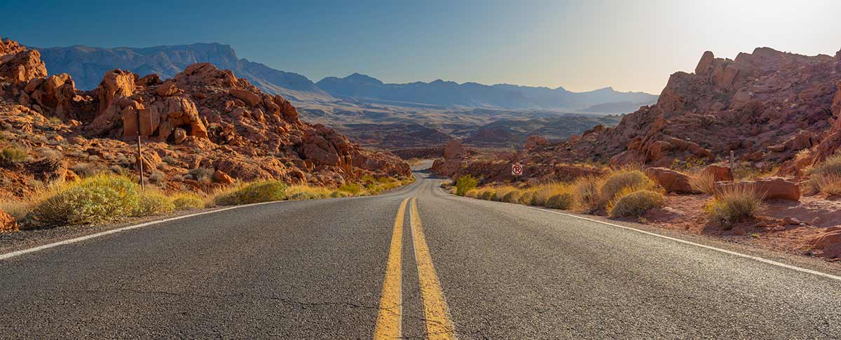 long and winding two lane road in an arid landscape